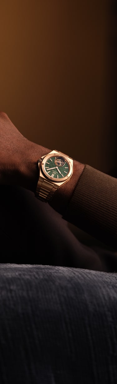 Close up of IWC Ingenieur Tourbillon 41 with green dial, and gold strap.