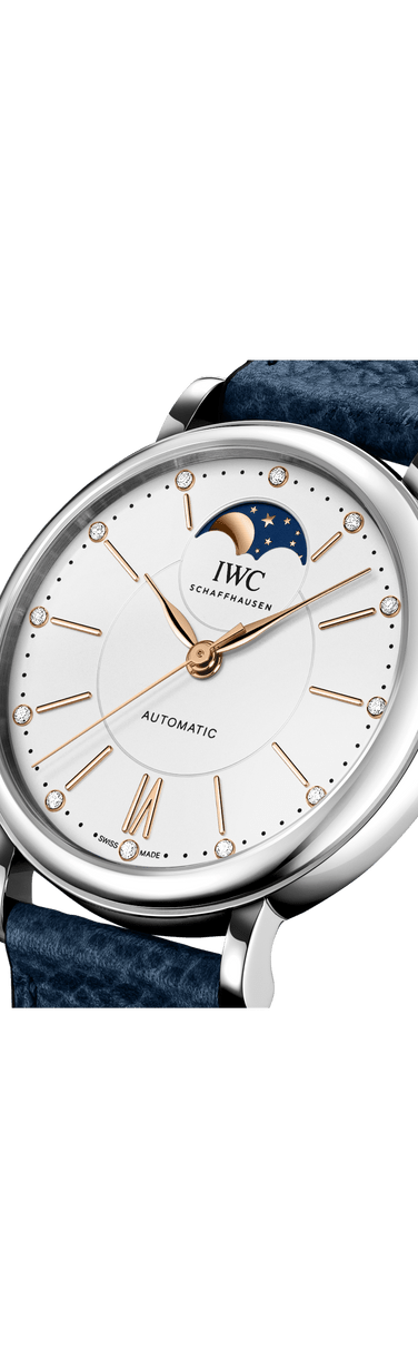 IWC Portofino Automatic Moon Phase with silver plated dial and brown calfskin strap on a grey surface.
