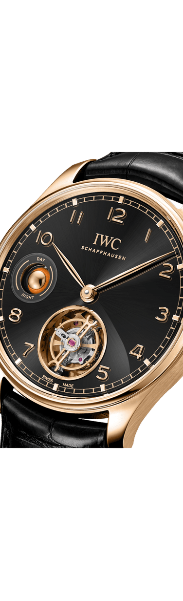 Close up image of IWC Portugieser Hand-Wound Tourbillon Day & Night with black dial, 18 ct Armor Gold® Case and black alligator leather strap by Santoni.