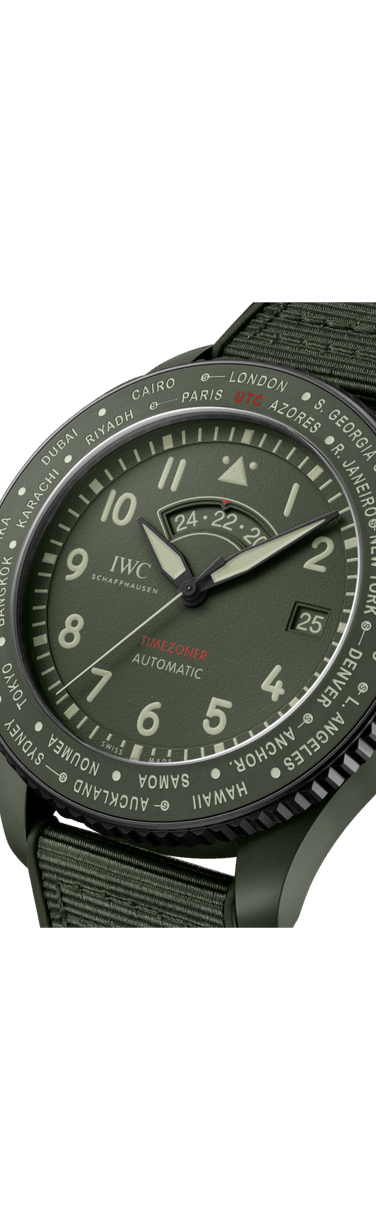 Close up image of IWC Pilot’s Watch Timezoner TOP GUN Woodland with green dial, ceramic case and green rubber strap with textile inlay.