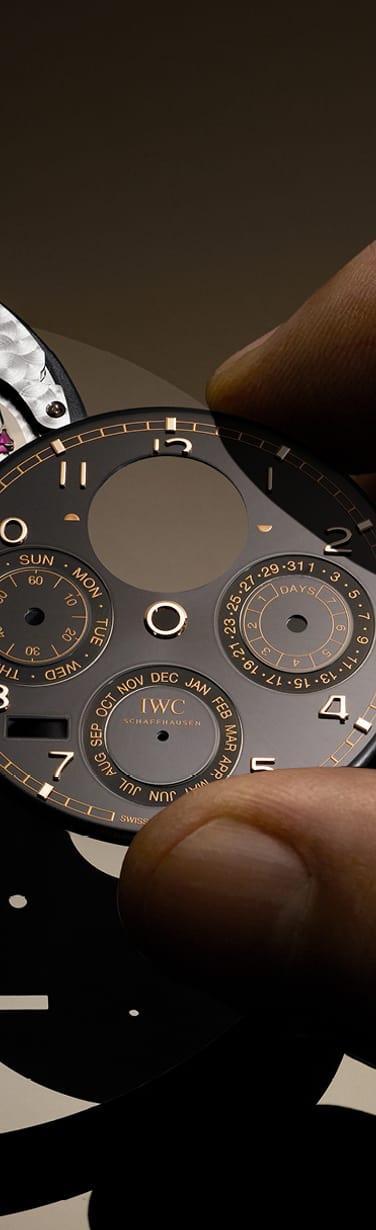 Close up on hands putting black dial of IWC Portugieser Perpetual Calendar on its mechanism