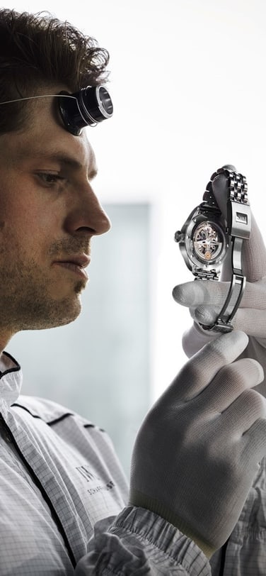 Watchmaker holding a watch