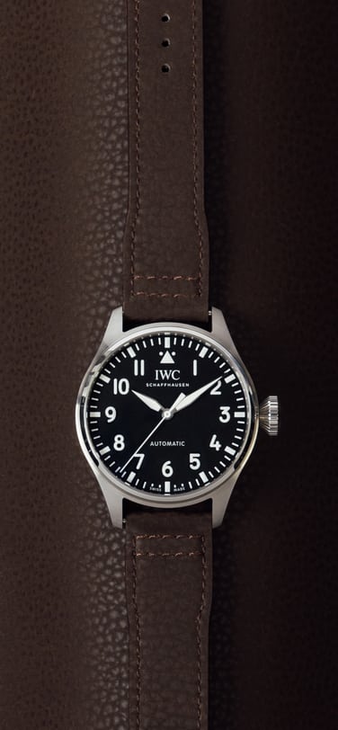Front image of a watch with brown alternative leather strap.
