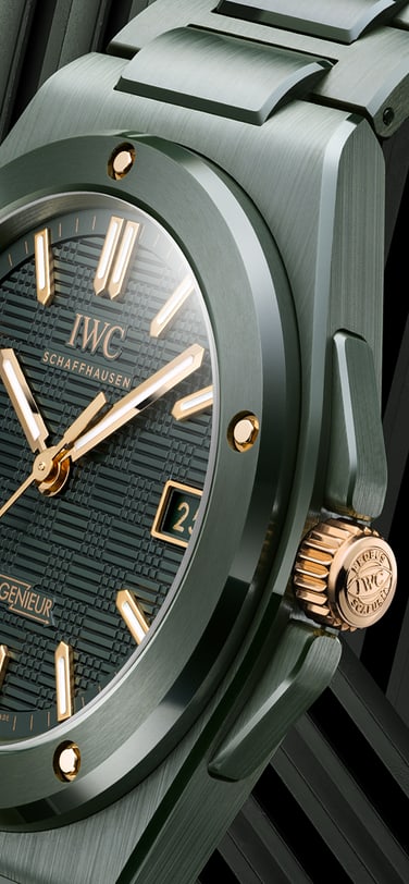 IWC Ingenieur Automatic 42 in a dark green ceramic finish with gold accents and green ceramic bracelet against a geometric background