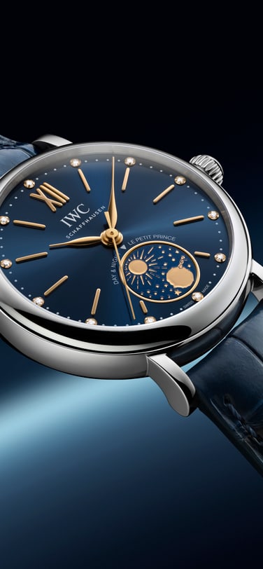 IWC Portofino watch with blue dial and day-night display on a leather strap, set against a space-inspired background