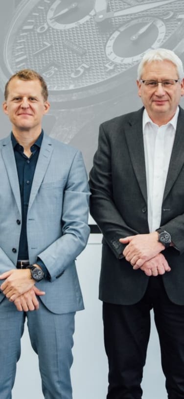 Four men including scientists and CEO in suits standing next to each other