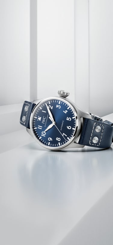 IWC Big Pilot's Watch with blue dial and blue leather strap lying on a white surface