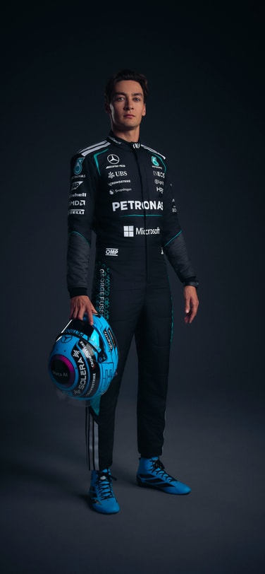 Grand Prix-winner and IWC brand ambassador George Russell in black uniform with brand logos wearing IWC watch.