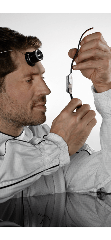 An IWC watchmaker conducting a final inspection of the Portugieser Eternal Calendar IW505701