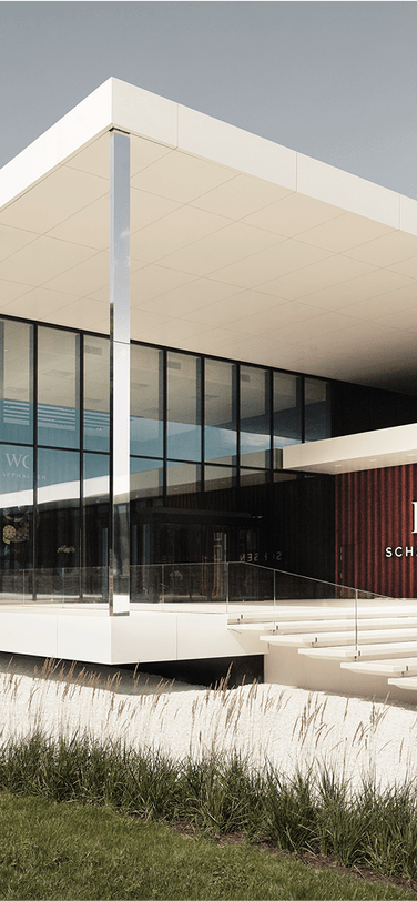 IWC headquarters with an elegant sleek building surrounded by greenery