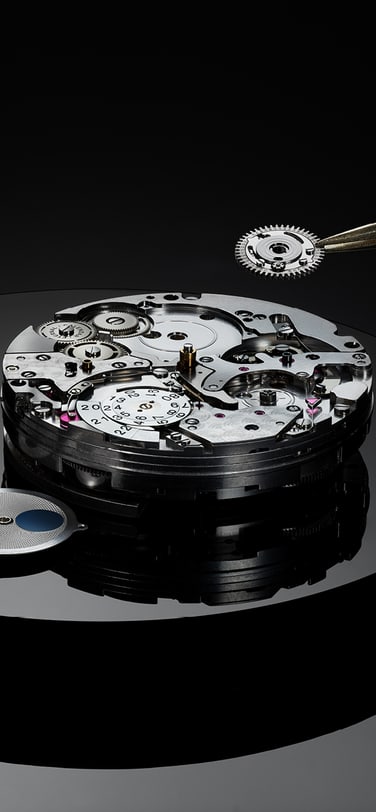 Portugieser Eternal Calendar watch dial unassembled on a black surface