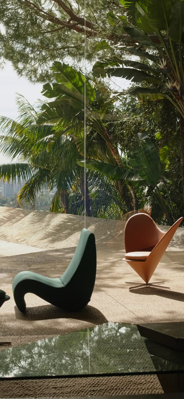 The modernist interior of the Goldstein Residence with the Los Angeles skyline view featuring iconic Vitra furniture by Verner Panton, including the "Heart Cone Chair" and "Cone Chair".