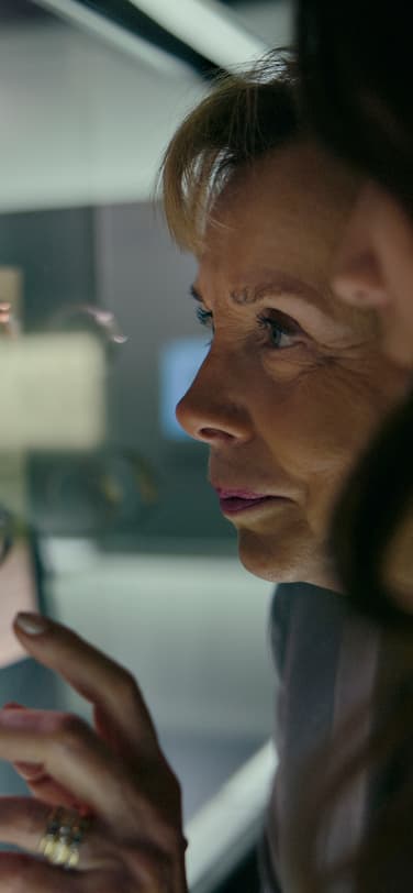 Two women, Evelyne and Alexia Genta, looking at IWC watches displayed at the IWC Museum.