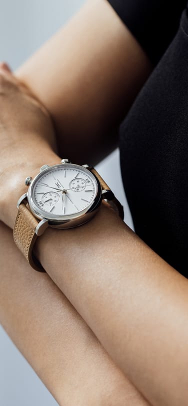 Portofino Chronograph 39 with white dial, steel case and beige calfskin strap on a woman's wrist