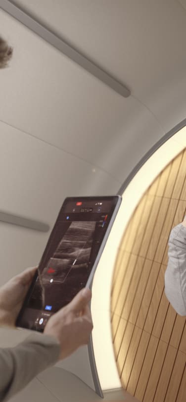 A man monitors a woman’s health with a tablet showing medical scans in the futuristic interior of a space station.