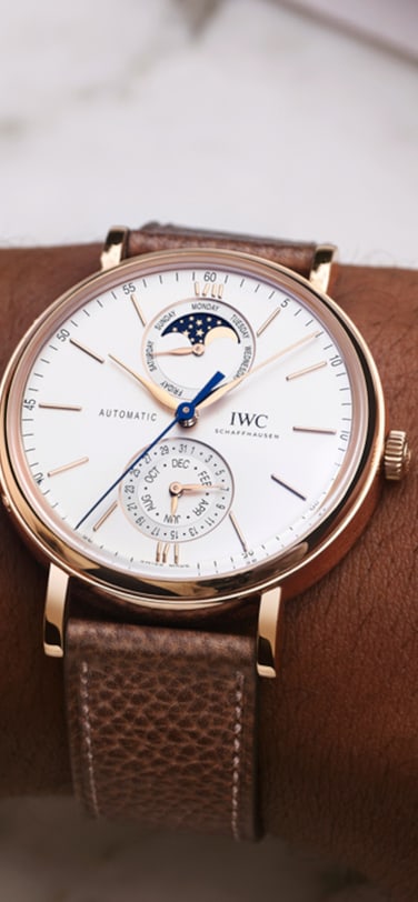 IWC Portofino Complete Calendar IW359002 with white dial, gold case and taupe calfskin strap.