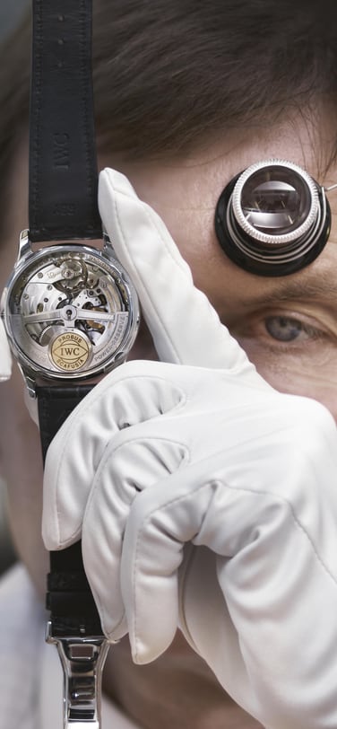 Image showing IWC watchmaker holding an IWC watch