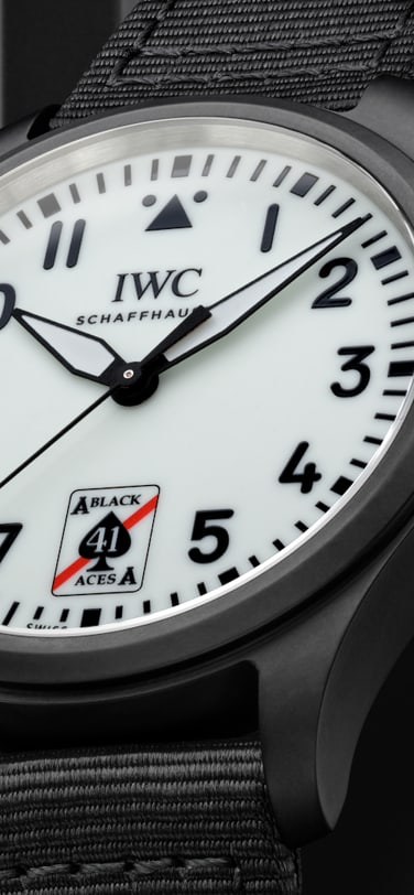 Clode up of the Pilot's Watch Automatic 41 Black Aces case and strap, white dial with black numbers and in place of 6'o'clock, features a stylized Ace of spades logo withred strip and number 41