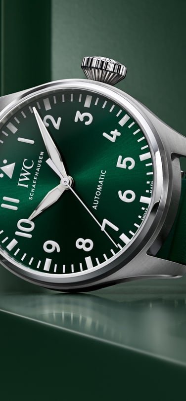 Front image of a green dial watch with a green rubber strap.