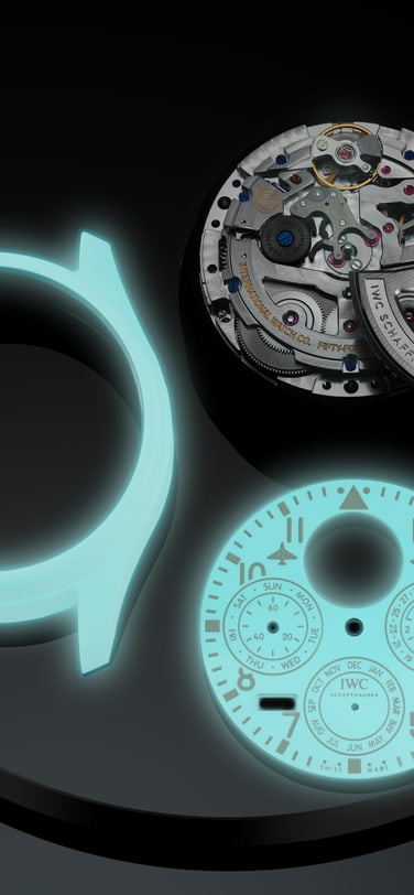 IWC Big Pilot’s Watch Perpetual Calendar Ceralume® (ref. IW505801) luminescent ceramic case and movement components laid out during assembly on a dark surface
