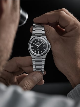 A man holding Ingenieur Automatic watch with black dial in his hands