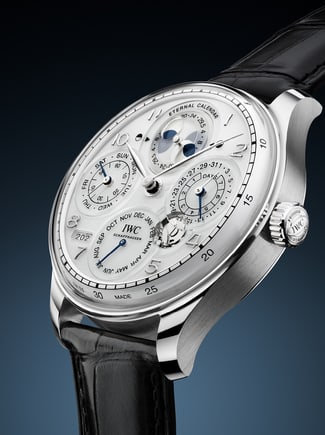 Front image showcasing the Eternal Calendar Watch with white dial and black strap on dark blue gradient background