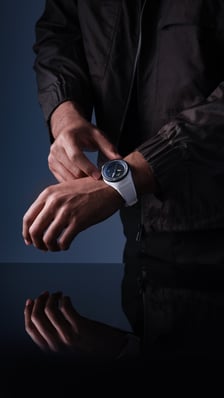 Pilot’s Venturer Vertical Drive on the wrist of a man; a space-certified mechanical watch with a white case and strap, and a black bezel.