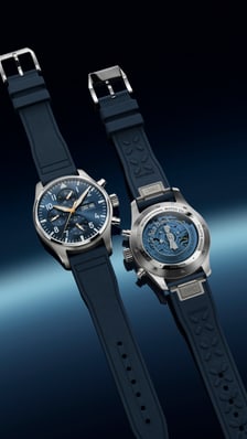 Two IWC Pilot's Chronograph watches displayed on a dark atmospheric background evoking the night sky