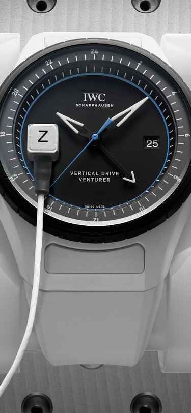 A watch featuring a black dial and white rubber strap undergoing testing and qualification for spaceflight.