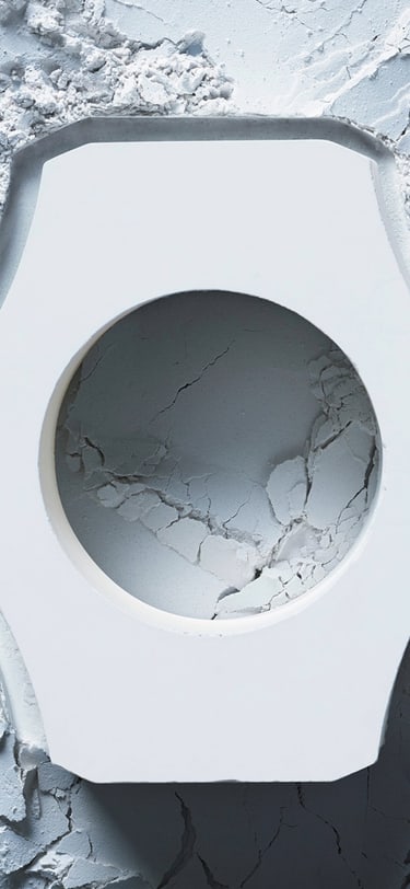 White ceramic case in the forground lying on top of ceramic material