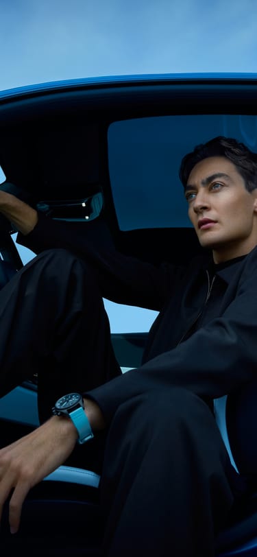 George Russell sitting in the car wearing the the Pilot's Watch Chronograph 41 George Russell watch