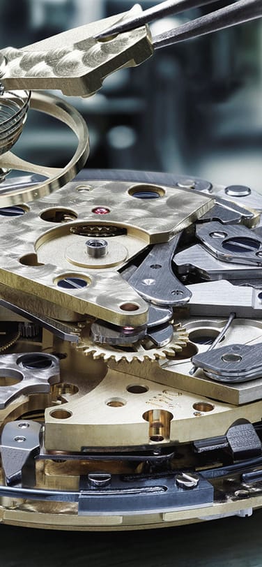 Close-up image of IWC watch mechanism and components inside watch dial