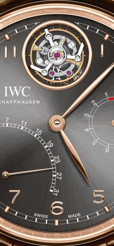 The IW504602 Portugieser Tourbillon Mystère Rétrograde with black dial and gold case