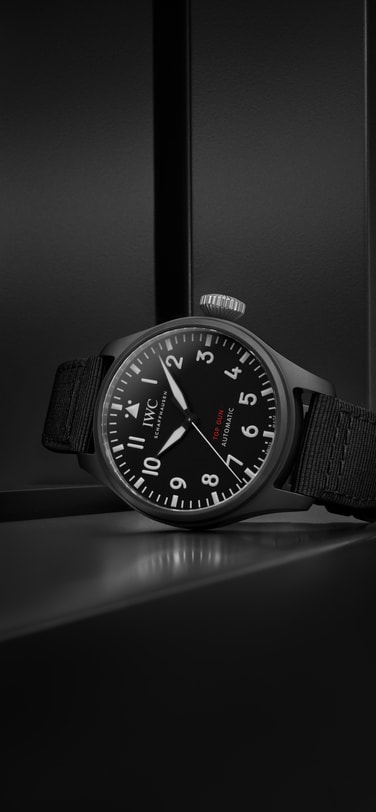 BIG PILOT’S WATCH 43 TOP GUN IW329801 in the forground in front of a black background.