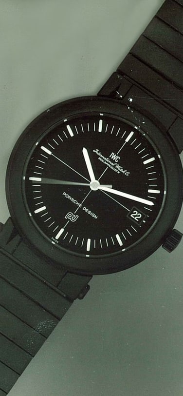 Image showing the IWC Porsche-Design compass watch with black dial and black strap,IWC Schaffhausen logo