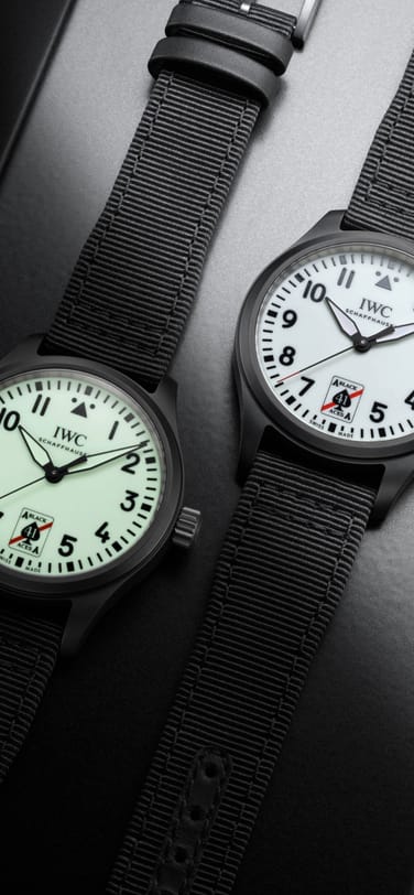 Two Pilot'sWatch Automatic 41 Black Aces side by side, the left watch dial is displaying it's glow in the dark functionality