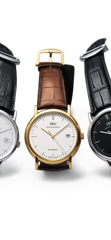 Three IWC Portofino Automatic watches with black and brown leather straps on white background