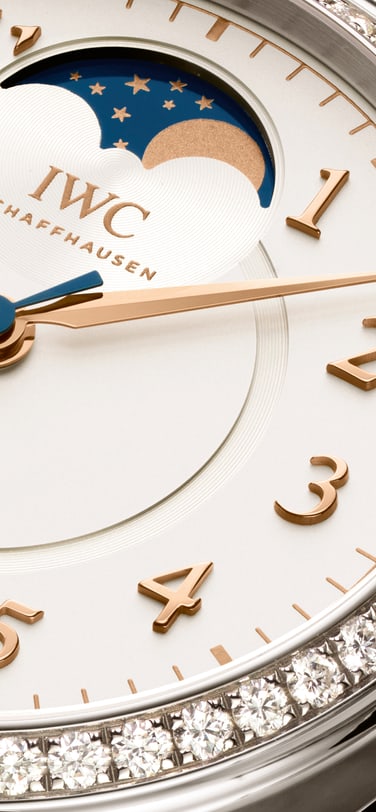 Partial view of an IWC watch where the 9 on the dial is visible.