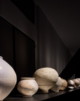 Various kinds of moon jars on black background.