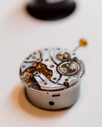 Close-up of an IWC watch movement, showcasing the gears, jewels, and intricate details.