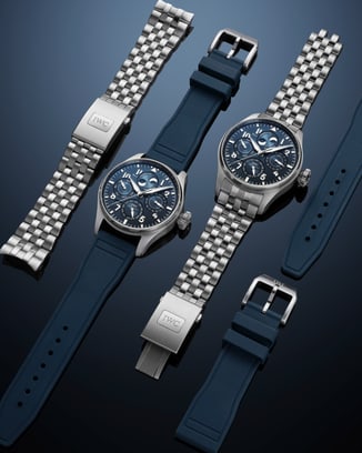 Two IWC Big Pilot's Watch models displayed side by side showcasing stainless steel bracelet, and blue rubber strap options