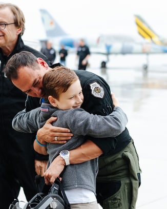 ‘Slick’ getting a big hug for good luck from his son, Jack