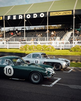 Two vintage cars at the Goodwood Festival of Speed