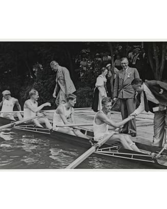 black and white image showing the Homberger Brothers and other people on a kayak