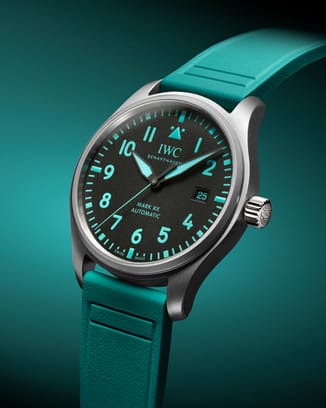 Front shot of a mechanical watch featuring a titanium case, black dial and Petronas green details and rubber strap