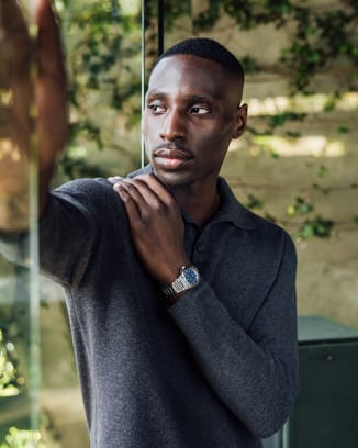 Male model wearing a stainless-steel sports watch with blue dial