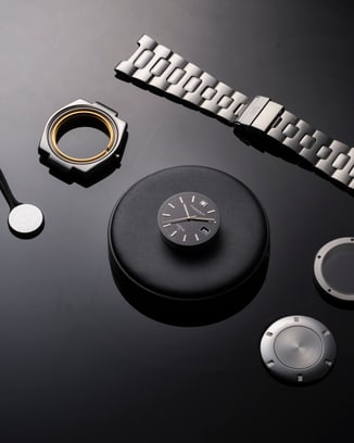 Ingenieur SL watch parts on black surface.