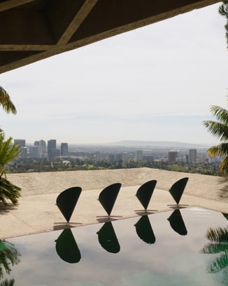 Four of Verner Panton’s Cone Chairs placed next to a reflecting pool in the Goldstein villa with a view on Los Angeles.