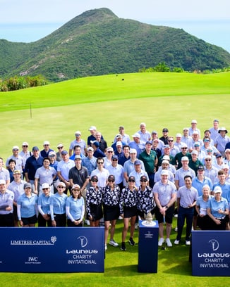 Participants of a Laureus Academy event posing together in a large group photo
