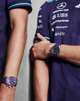 Body shot of George Russell (L) and Kimi Antonelli (R) wearing Petronas Team shirts and Pilot's Watch Chronograph 41 Mercedes-AMG Petronas Formula One™ Team watch.